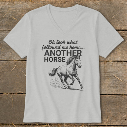 Light gray v-neck t-shirt with a drawing of a galloping horse and text "Oh look what followed me home... ANOTHER HORSE".