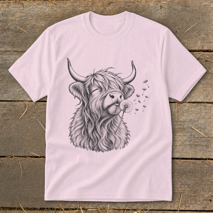 Pink t-shirt with sketch of a shaggy Highland cow blowing a dandelion.