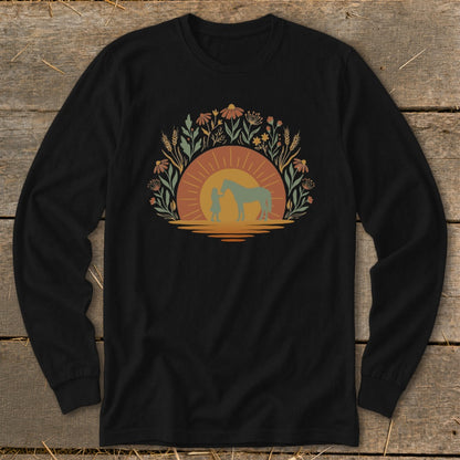 Black long-sleeve shirt with a circular floral design featuring a child and horse silhouetted against a sunset.