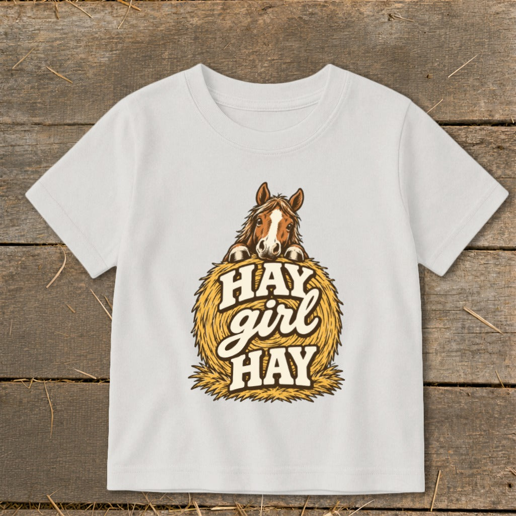White t-shirt with horse peeking over hay bale, saying "HAY girl HAY".