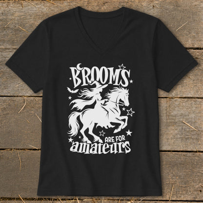 Black t-shirt with white graphic of witch riding horse and text "BROOMS ARE FOR AMATEURS".