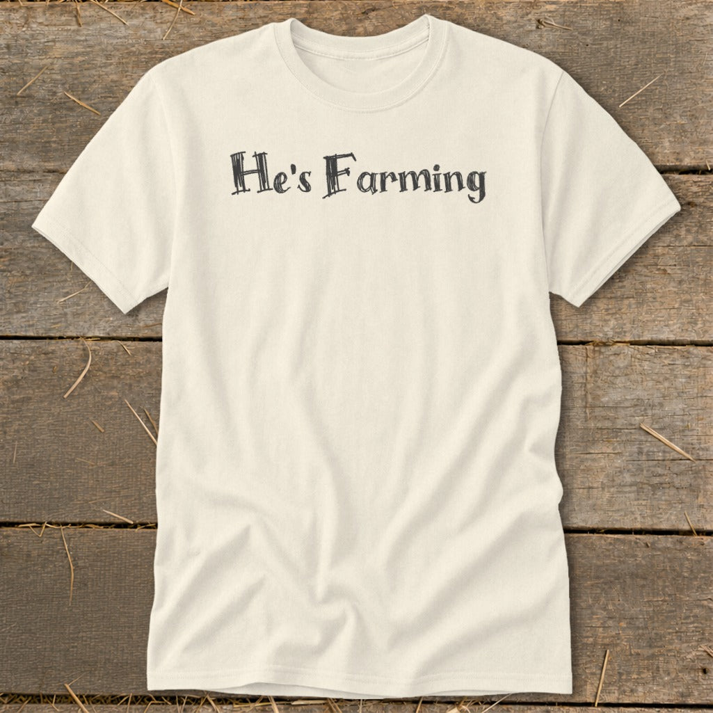 Cream t-shirt with "He's Farming" text in distressed black font.