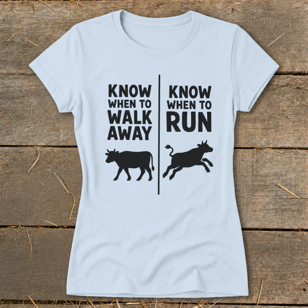 Light blue t-shirt with black text and cow graphics reading "Know When to Walk Away" and "Know When to Run".