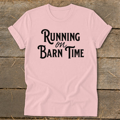 Pink t-shirt with black text reading "Running on Barn Time".