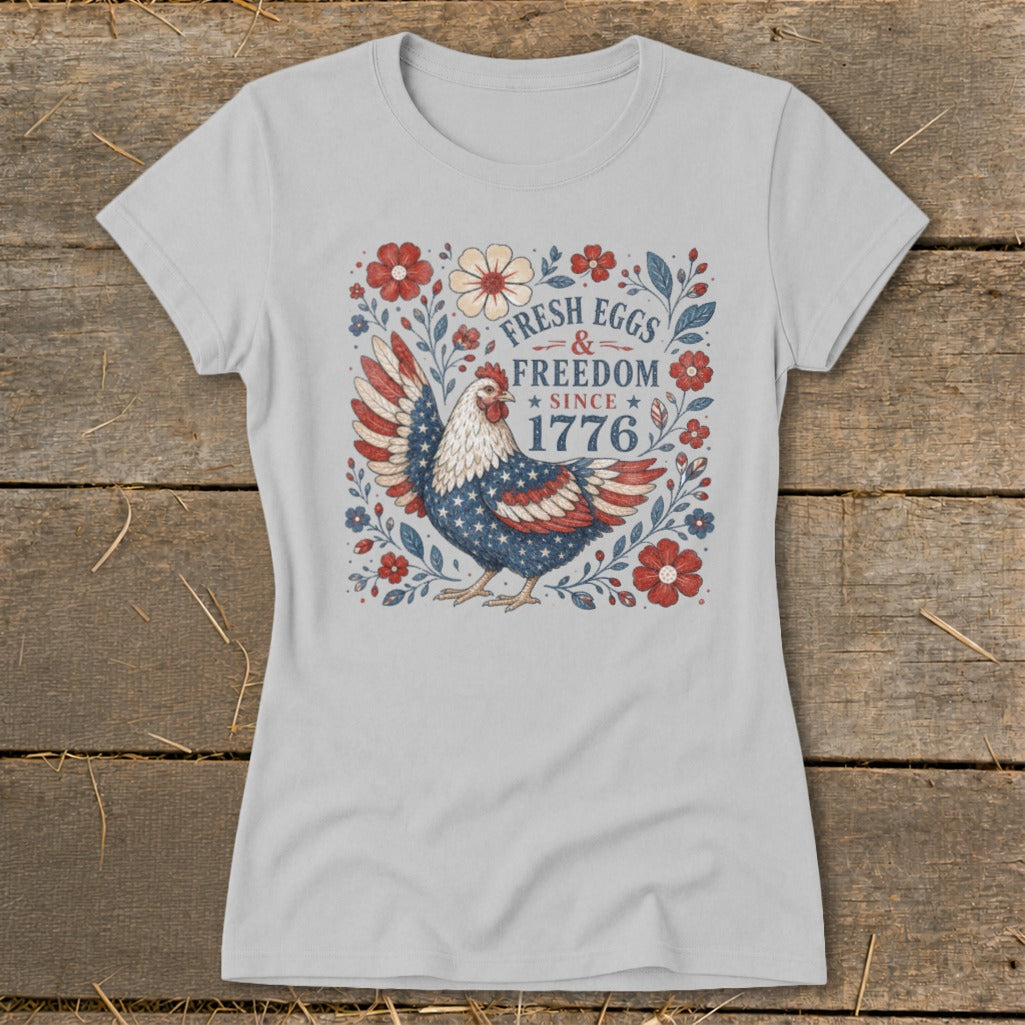 Chicken with American flag wings, "Fresh Eggs & Freedom Since 1776" text, surrounded by flowers.