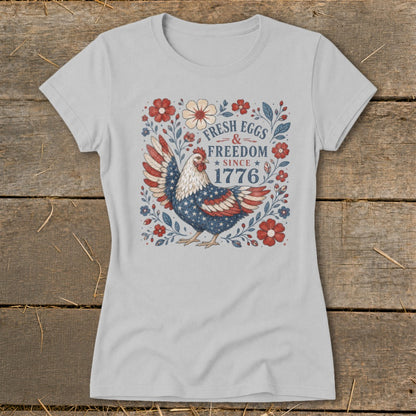 Chicken with American flag wings, "Fresh Eggs & Freedom Since 1776" text, surrounded by flowers.