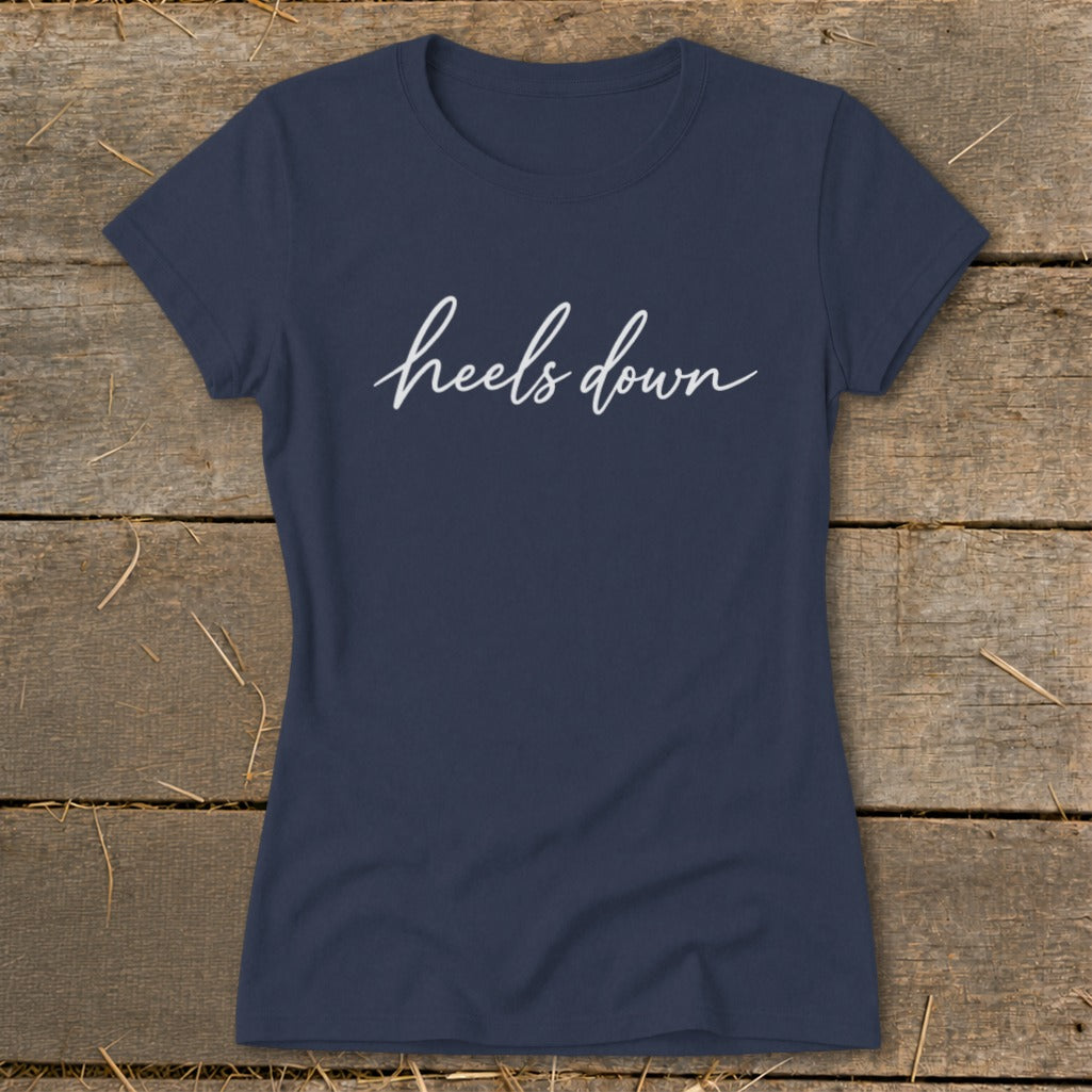 Navy blue t-shirt with "heels down" in white script text.