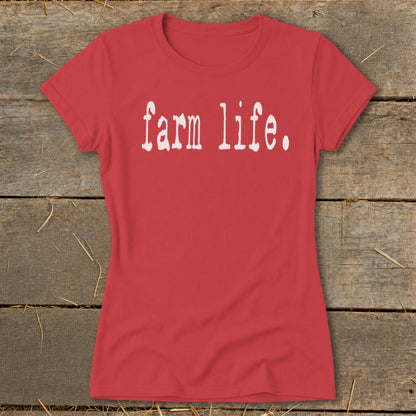 Red t-shirt with white "farm life." text on a wooden background.