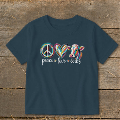 T-shirt with peace, love, cows design featuring a cow and colorful symbols.