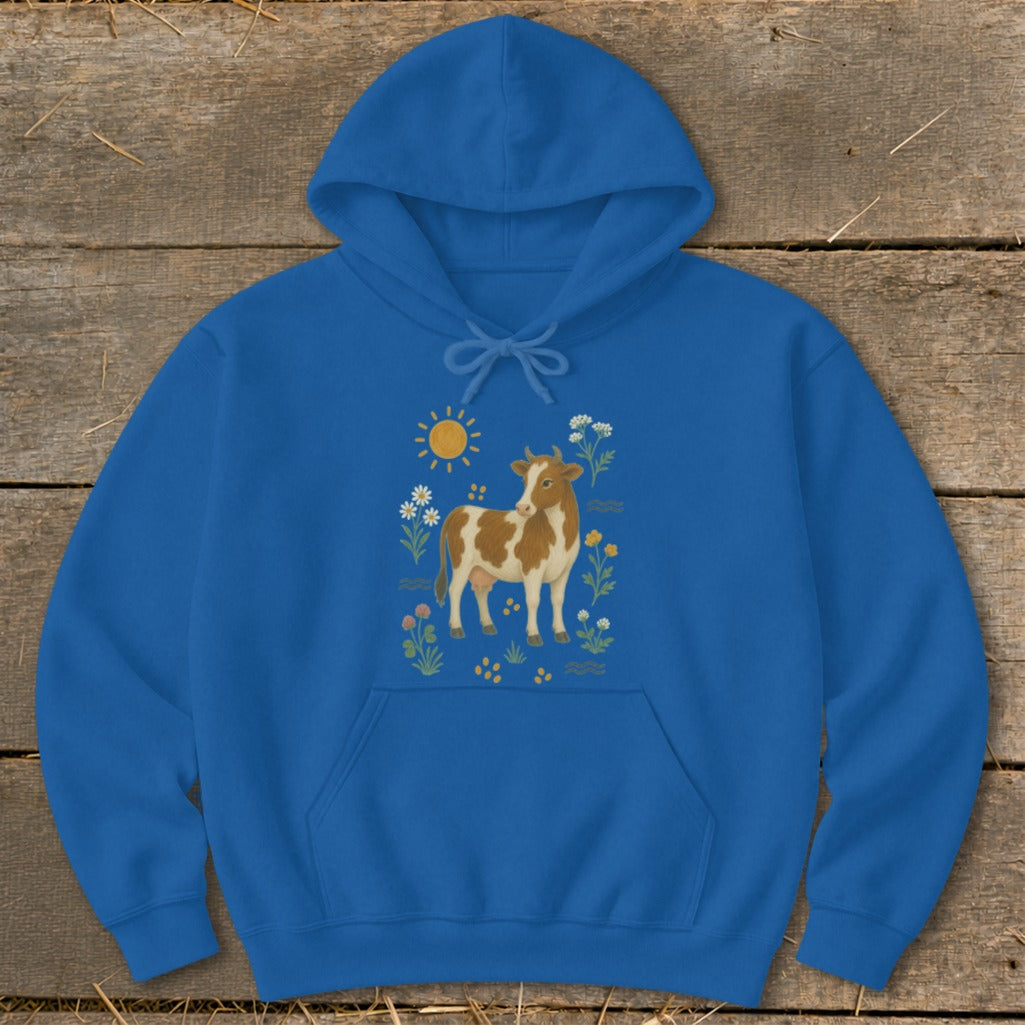 Blue hoodie with a brown and white cow, sun, and flowers illustration.
