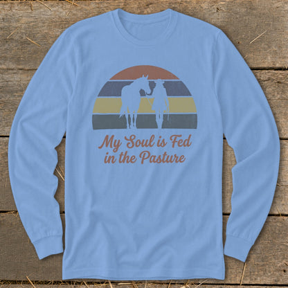 Light blue long-sleeve shirt with horse and rider silhouette and text.