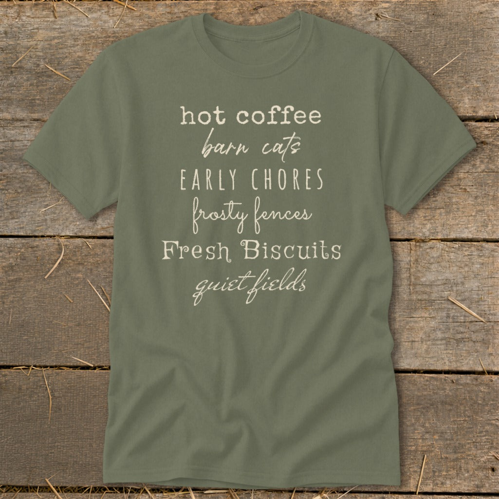 Olive green t-shirt with text: hot coffee, barn cats, EARLY CHORES, frosty fences, Fresh Biscuits, quiet fields.