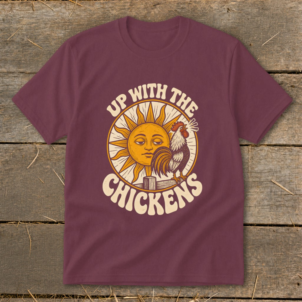 Maroon t-shirt featuring a retro graphic of a sun, a rooster, and the text Up With The Chickens.