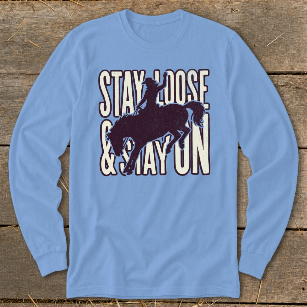 Light blue long-sleeve shirt with "STAY LOOSE & STAY ON" text and bucking horse graphic.