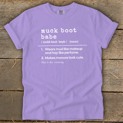 Lavender Comfort Colors t-shirt with "muck boot babe" definition printed in white.