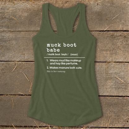Green tank top with "muck boot babe" definition printed in white text.