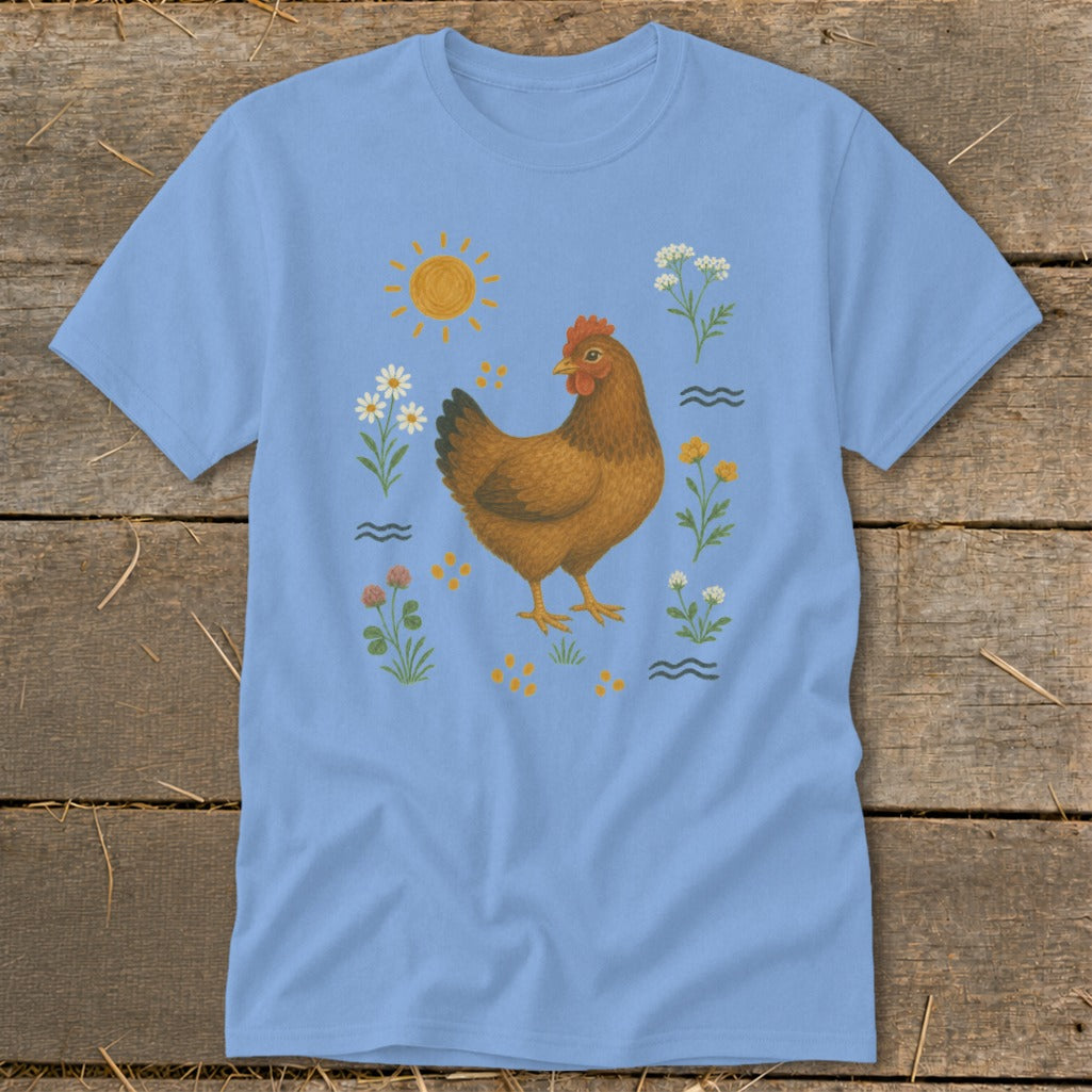 Light blue t-shirt with brown chicken, sun, flowers, and clover illustration.
