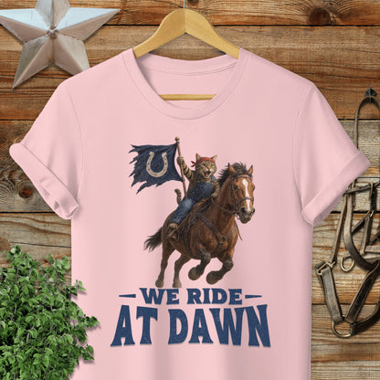 Cat in cowboy hat riding horse with "We Ride At Dawn" text.