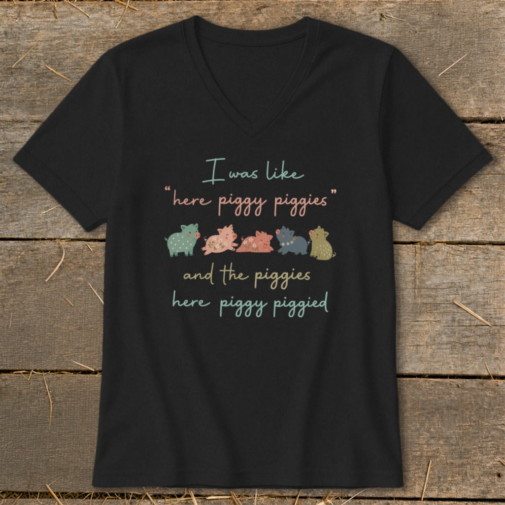 Black t-shirt with "I was like 'here piggy piggies' and the piggies here piggy piggied" and five colorful pigs.