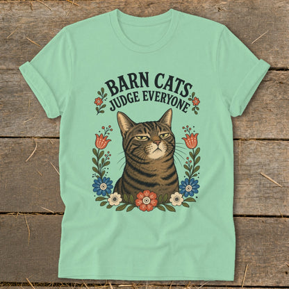 Mint t-shirt with a tabby cat and "Barn Cats Judge Everyone" text surrounded by flowers.