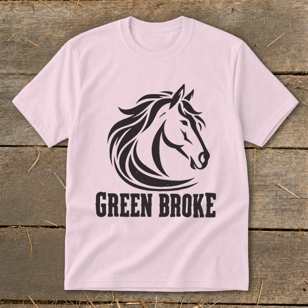 A light pink t-shirt with a black graphic of a horse's head and the text "GREEN BROKE" underneath.