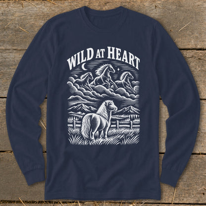 Navy blue long-sleeved t-shirt featuring a white graphic of horses, mountains, and the text Wild at Heart.