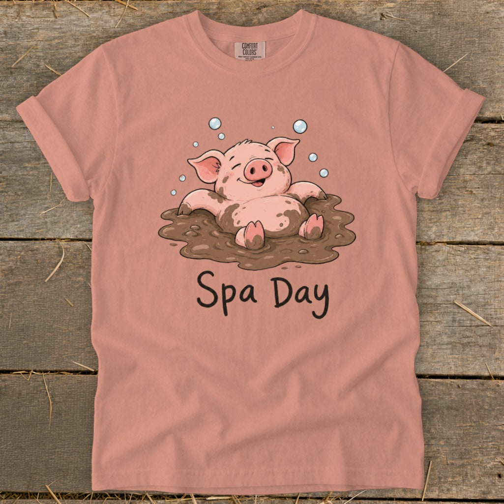T-shirt with illustration of a happy pig in mud and text "Spa Day."