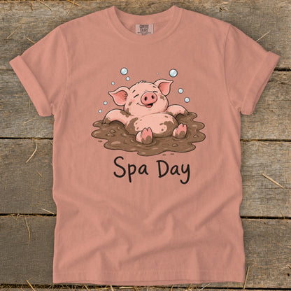 T-shirt with illustration of a happy pig in mud and text "Spa Day."