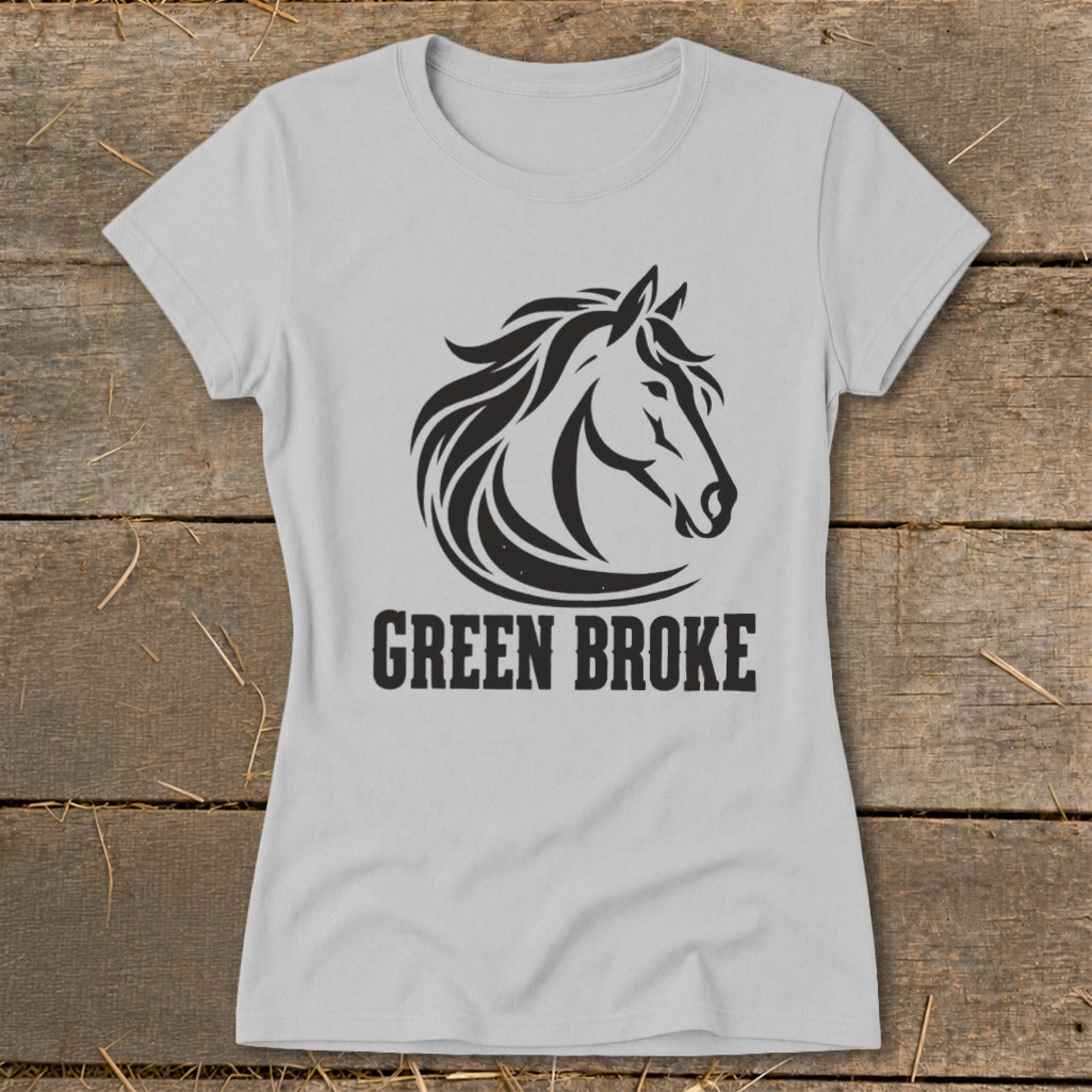 A light gray women's t-shirt featuring a black graphic of a horse head and the text Green Broke.