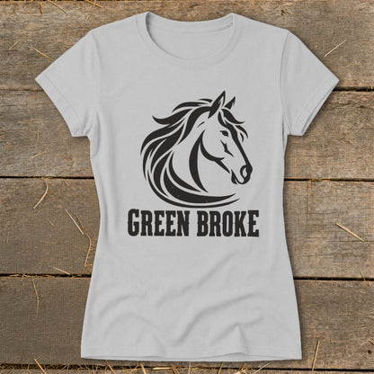 A light gray women's t-shirt featuring a black graphic of a horse head and the text Green Broke.