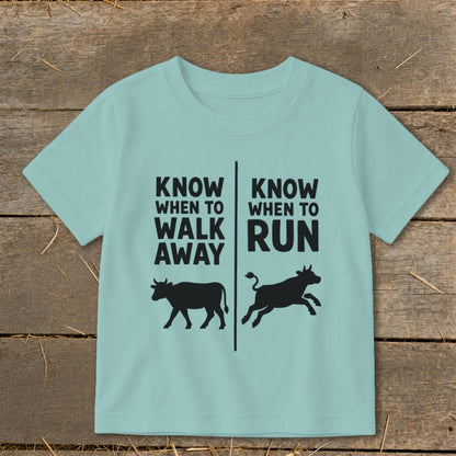Light blue t-shirt with "Know When to Walk Away" and "Know When to Run" text and cows.