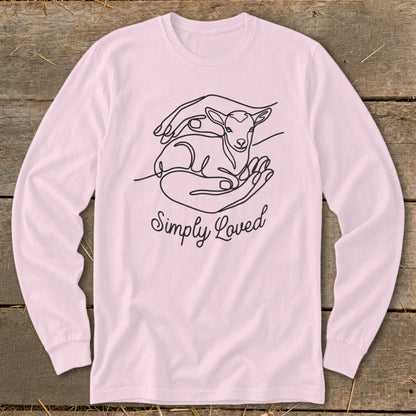 Long sleeve pink shirt with line art of hands holding a lamb and text "Simply Loved".