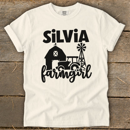 White t-shirt with "Silvia farmgirl" text and farm graphics.