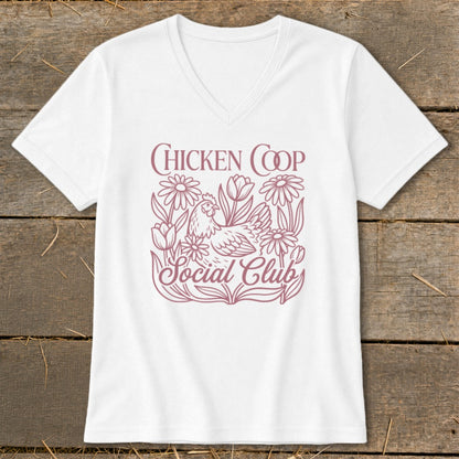 White v-neck t-shirt with "Chicken Coop Social Club" text and chicken and floral design.