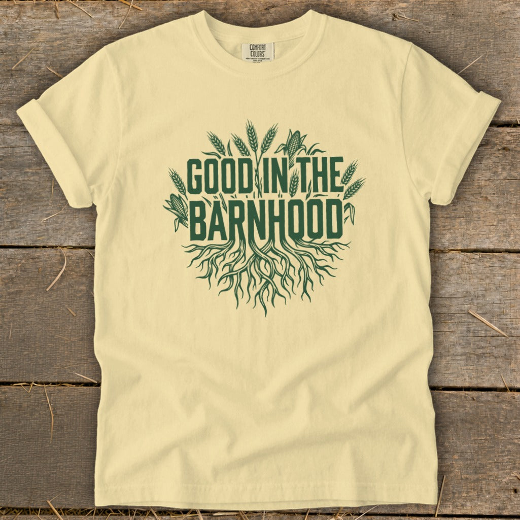 Light yellow t-shirt with green "GOOD IN THE BARNHHOOD" text and roots graphic.