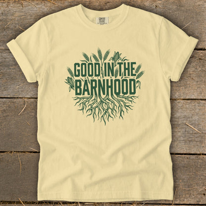 Light yellow t-shirt with green "GOOD IN THE BARNHHOOD" text and roots graphic.
