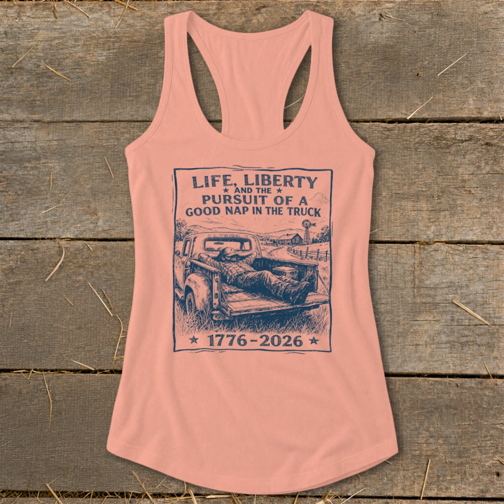 Peach tank top with graphic: "Life, Liberty and the Pursuit of a Good Nap in the Truck 1776-2026".