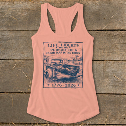 Peach tank top with graphic: "Life, Liberty and the Pursuit of a Good Nap in the Truck 1776-2026".
