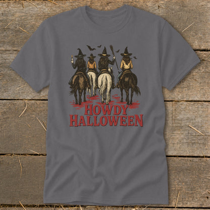 Four witches on horseback with bats overhead, text reads "Howdy Halloween".