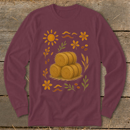 Burgundy long-sleeve shirt with a central stack of hay bales surrounded by autumn motifs.