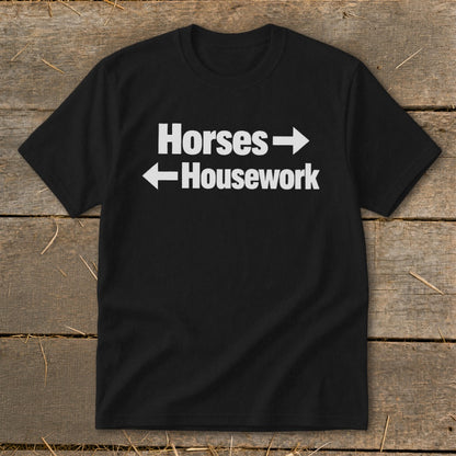 Black t-shirt featuring the white text Horses with a right arrow and Housework with a left arrow.