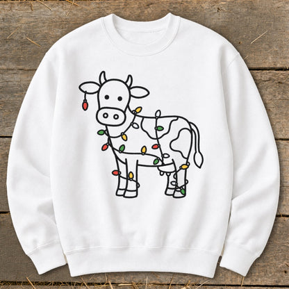 White sweatshirt with a black outline illustration of a cow wrapped in colorful Christmas lights.
