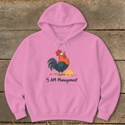 Pink hoodie with a cartoon rooster crowing at sunrise and the text "5 AM Management".
