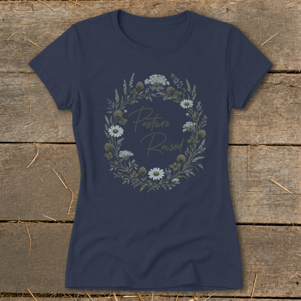 Navy t-shirt with "Pasture Raised" text inside a floral wreath.