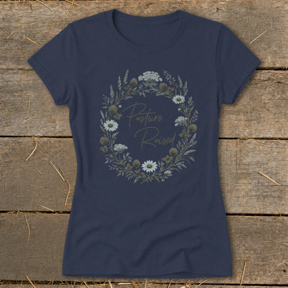 Navy t-shirt with "Pasture Raised" text inside a floral wreath.