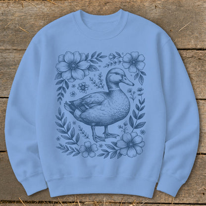 Light blue sweatshirt with a blue line drawing of a duck surrounded by flowers.