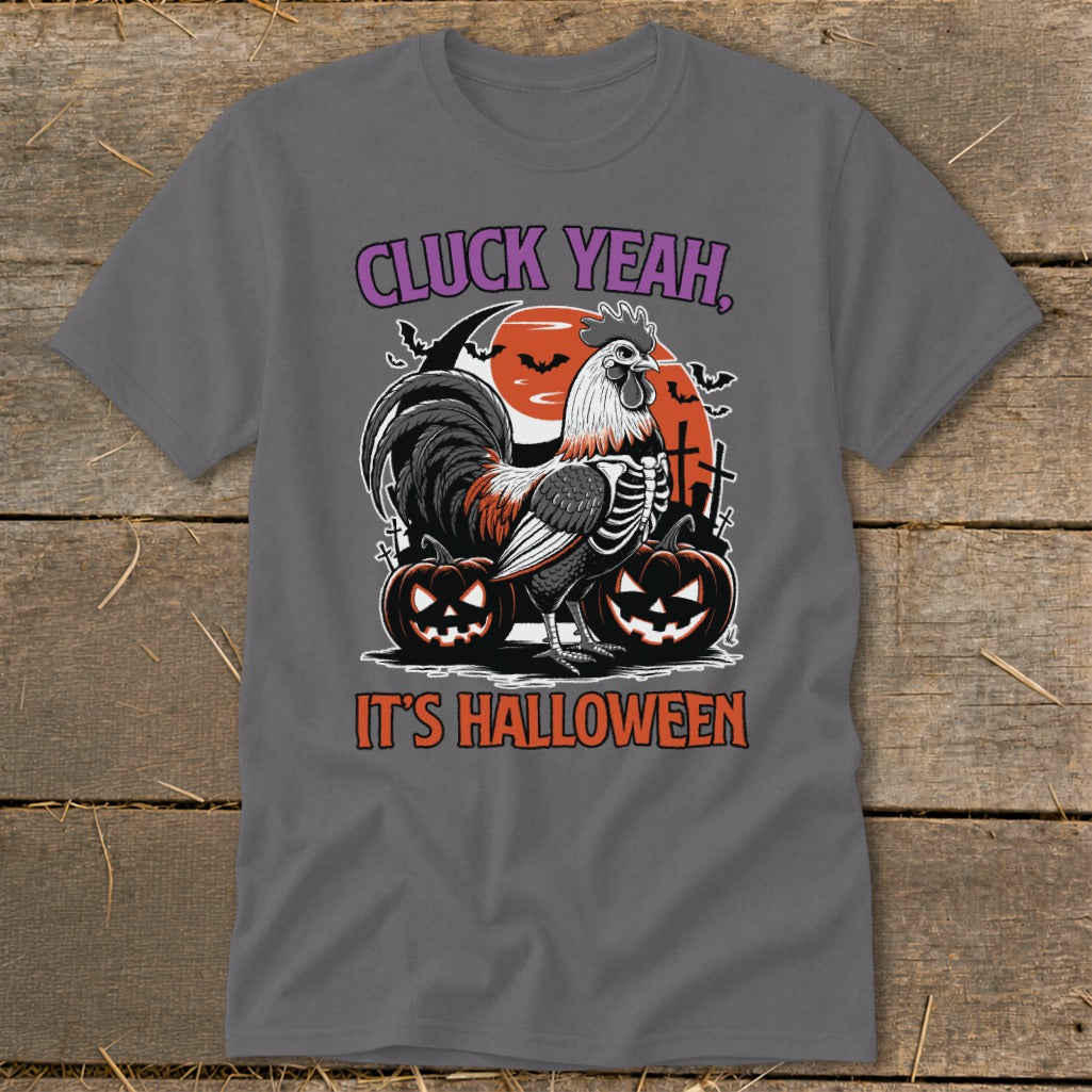 Gray t-shirt with a Halloween graphic featuring a rooster skeleton, pumpkins, and text "CLUCK YEAH, IT'S HALLOWEEN."