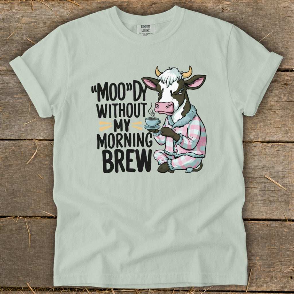 Cow in pajamas holding coffee with text "Moo"dy Without My Morning Brew.