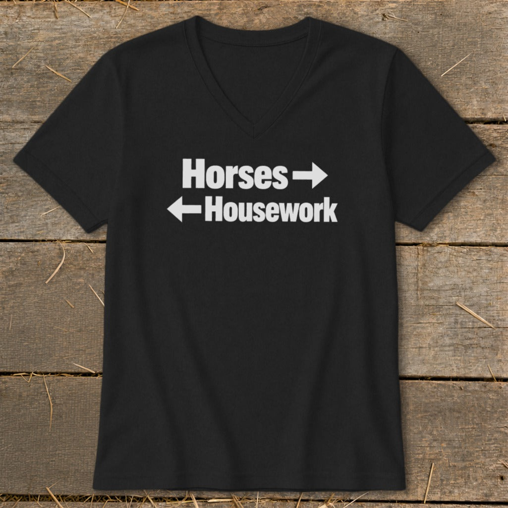 Black v-neck t-shirt featuring white text that reads Horses with a right arrow and Housework with a left arrow.