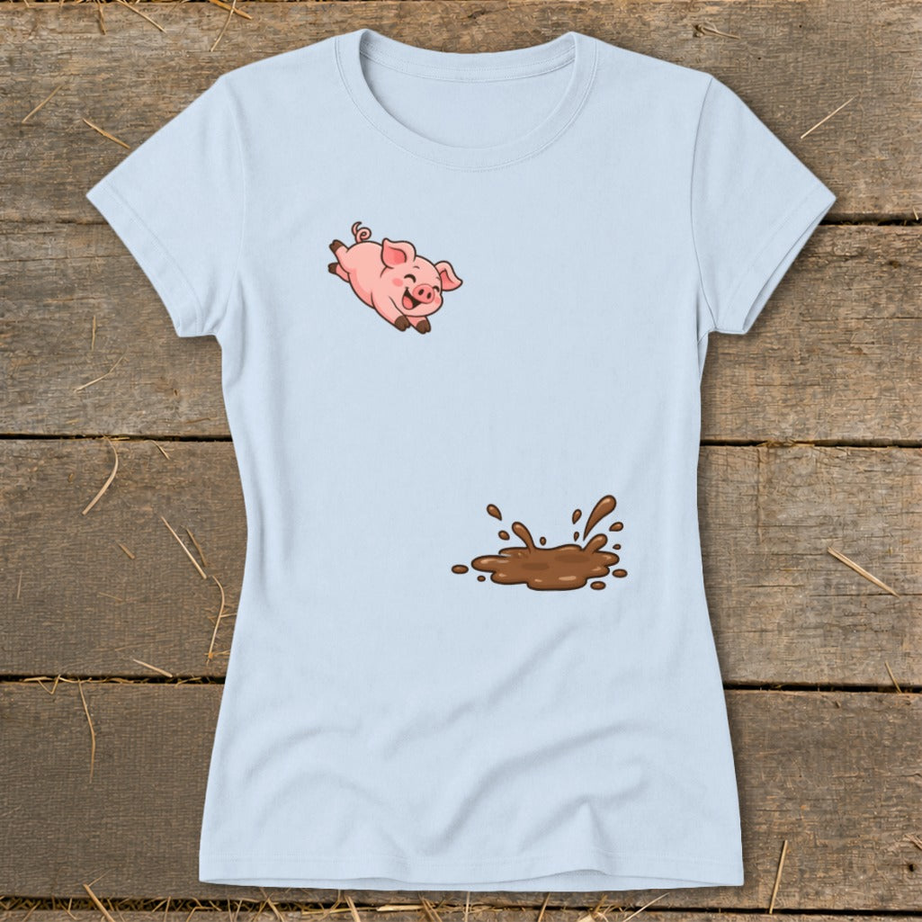 Light blue t-shirt with a cartoon pig jumping over a mud puddle graphic.
